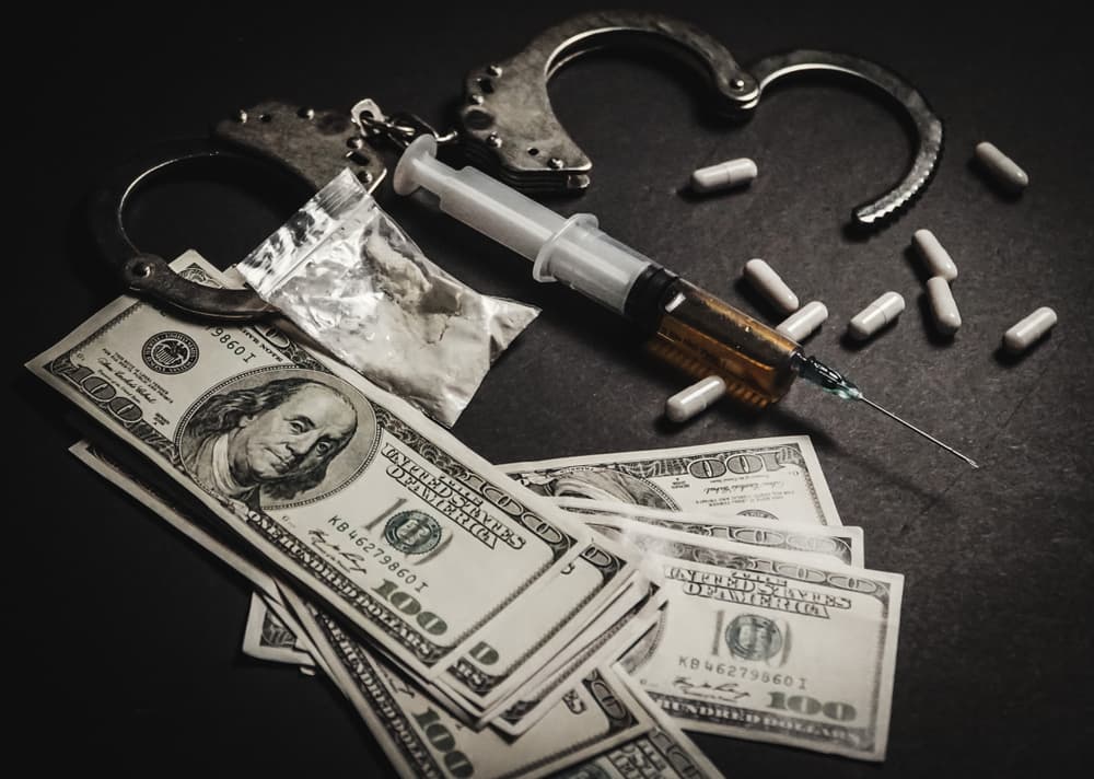 Concept of drug addiction and crime: justice, handcuffs, and weapons.






