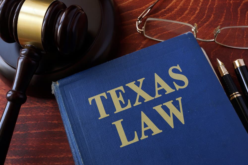 A book titled "Texas Law" with a gavel placed beside it.